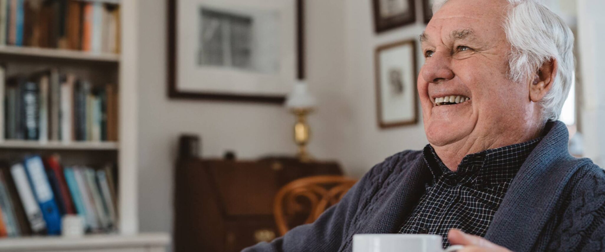 senior man enjoying a cup of coffee in his senior apartment