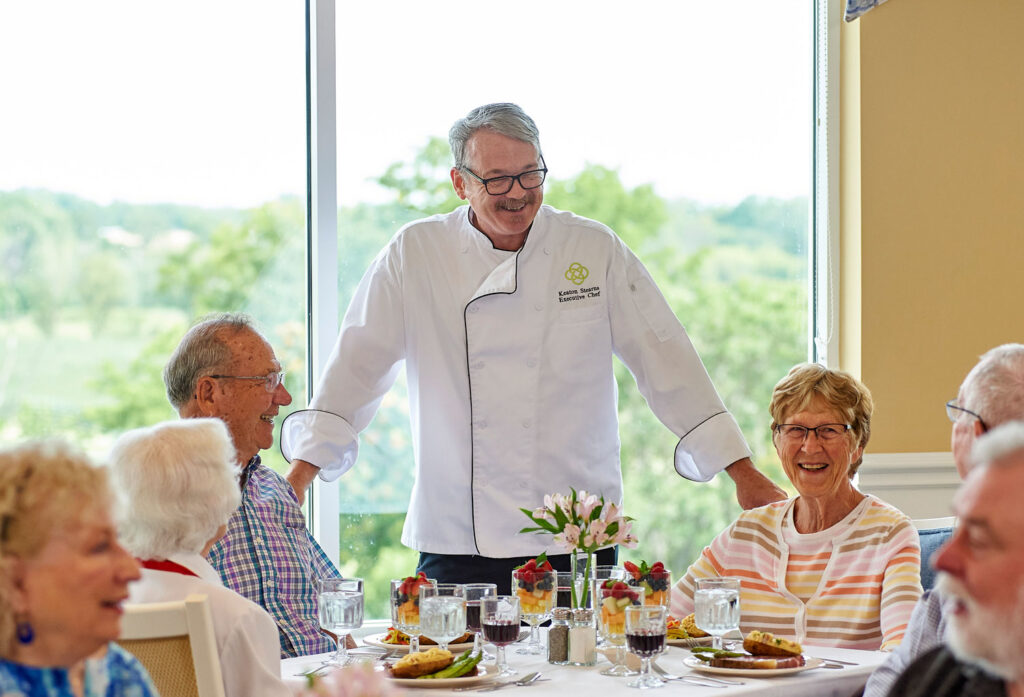 residents laughing with chef