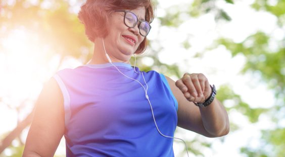 Happy senior woman checking her fitness watch