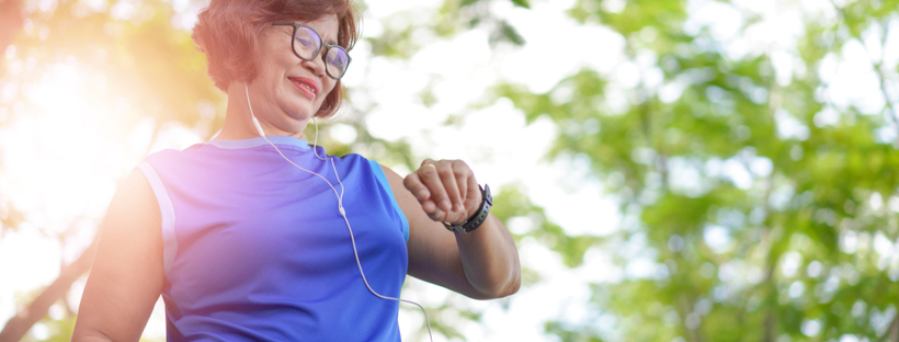 Happy senior woman checking her fitness watch