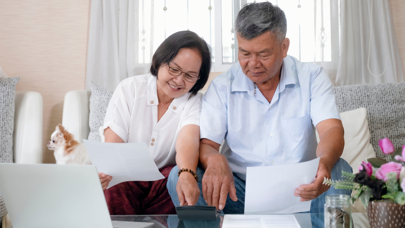 Couple calculating costs of senior living together