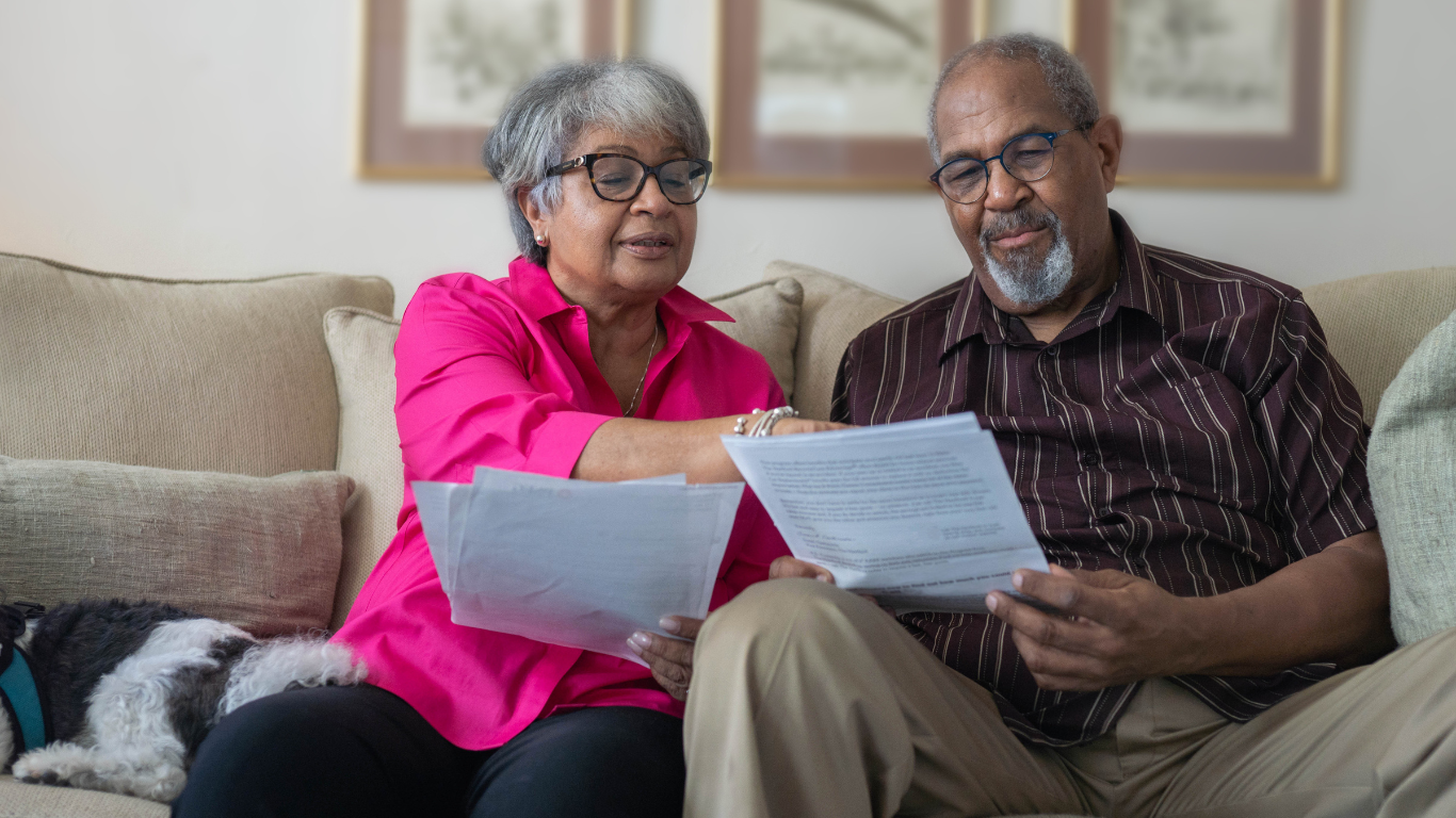 Senior couple looking over contracts together