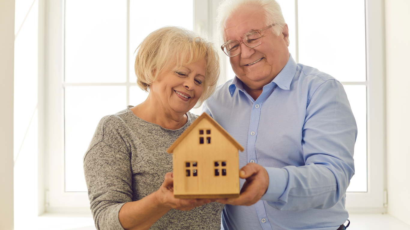 Blog Images (69) Senior couple holding a doll-sized house together