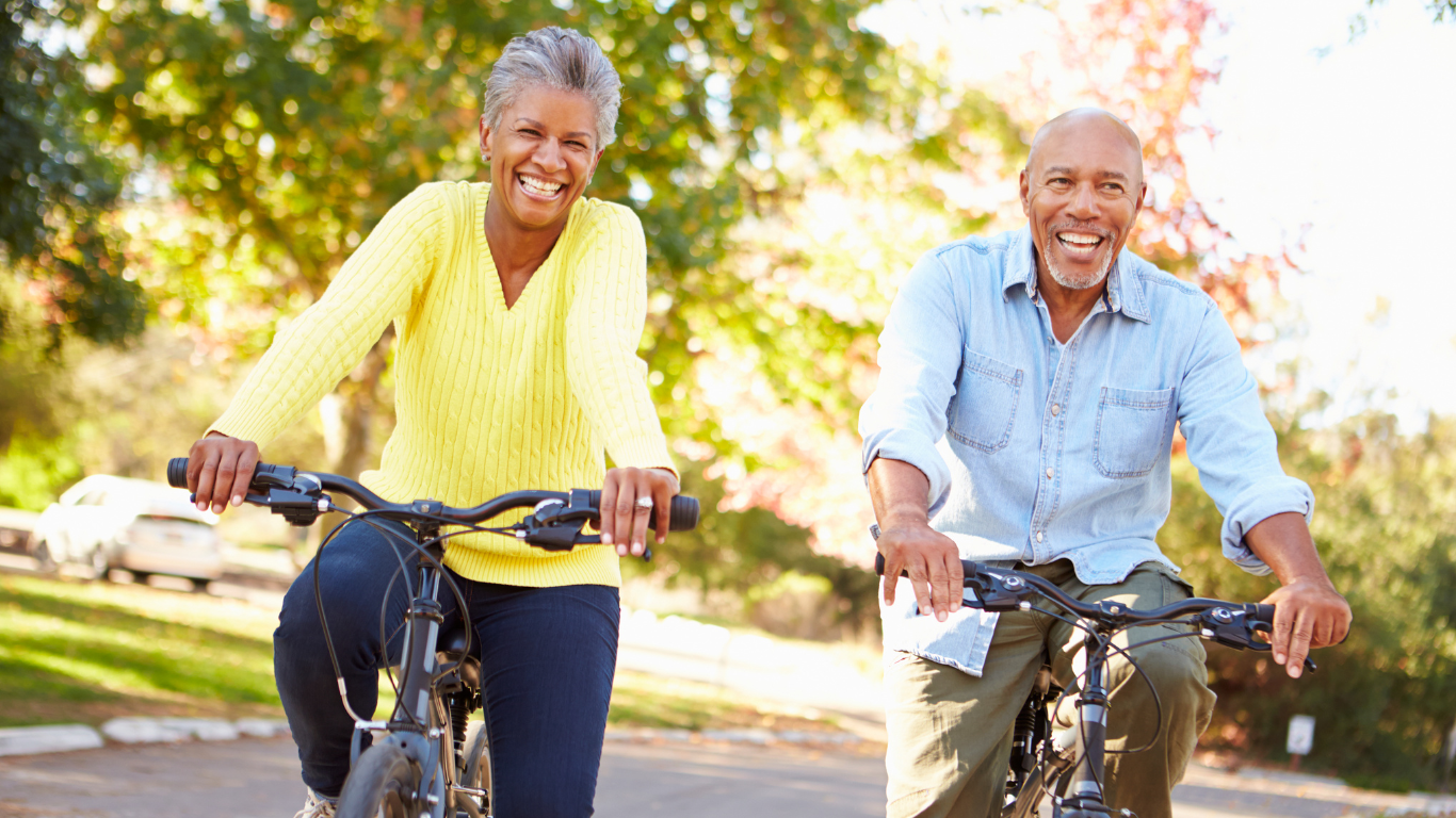 Senior couple smiling while on a bike ride together