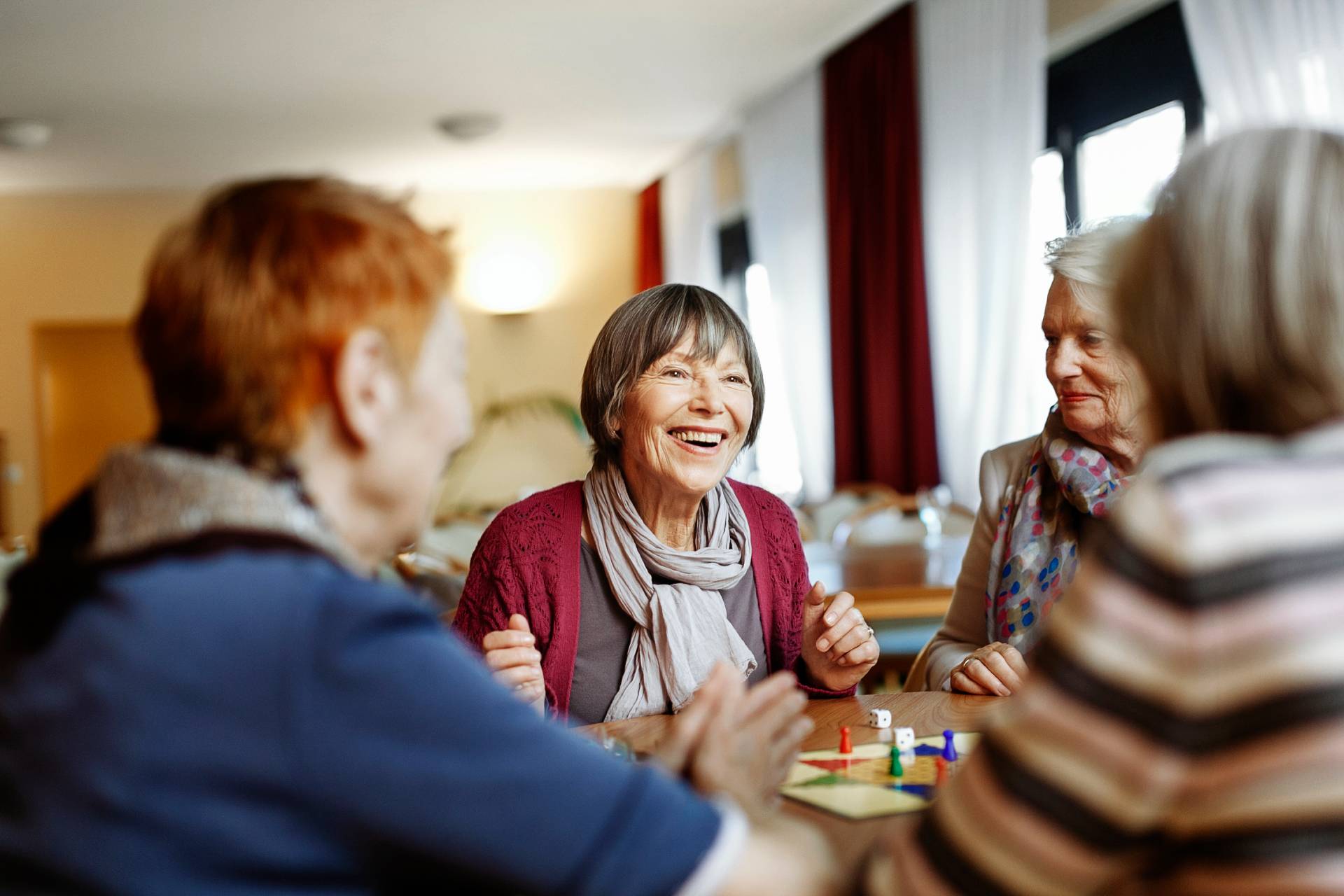 happy seniors in a retirement community talking with friends