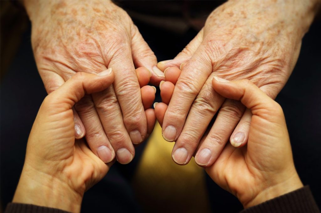 close up of senior holding hands
