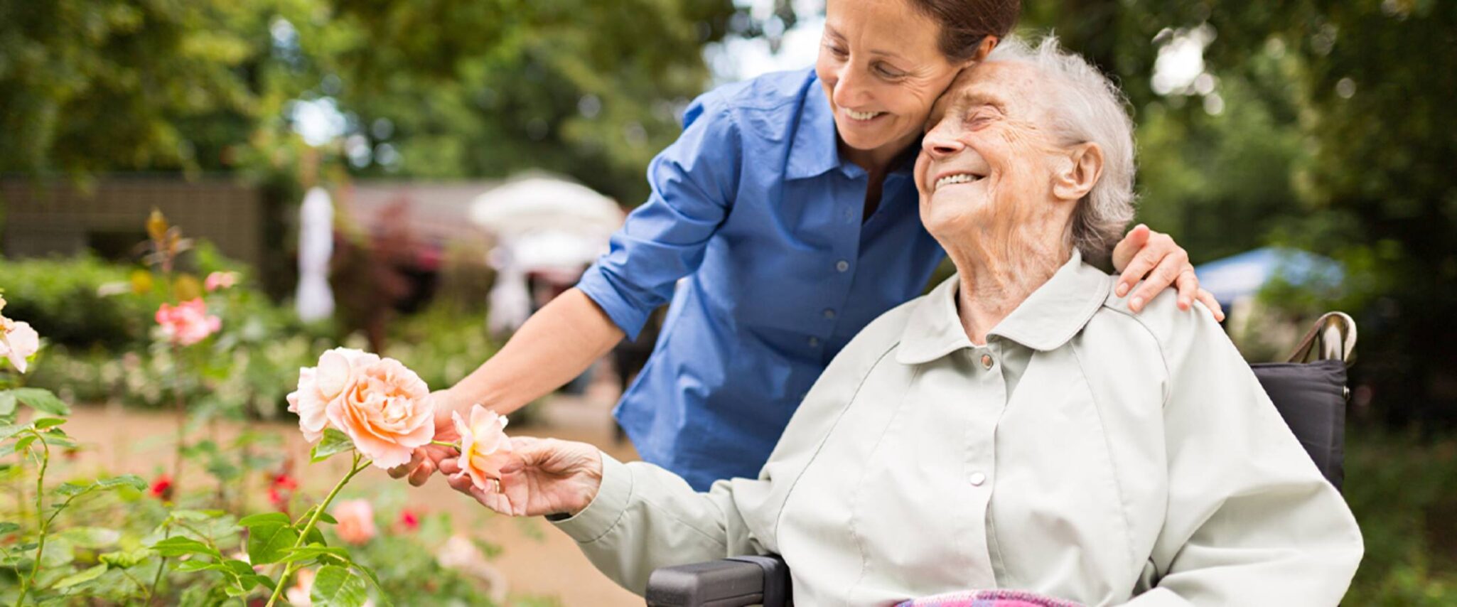 Senior woman holding flowers on a walk in her retirement community