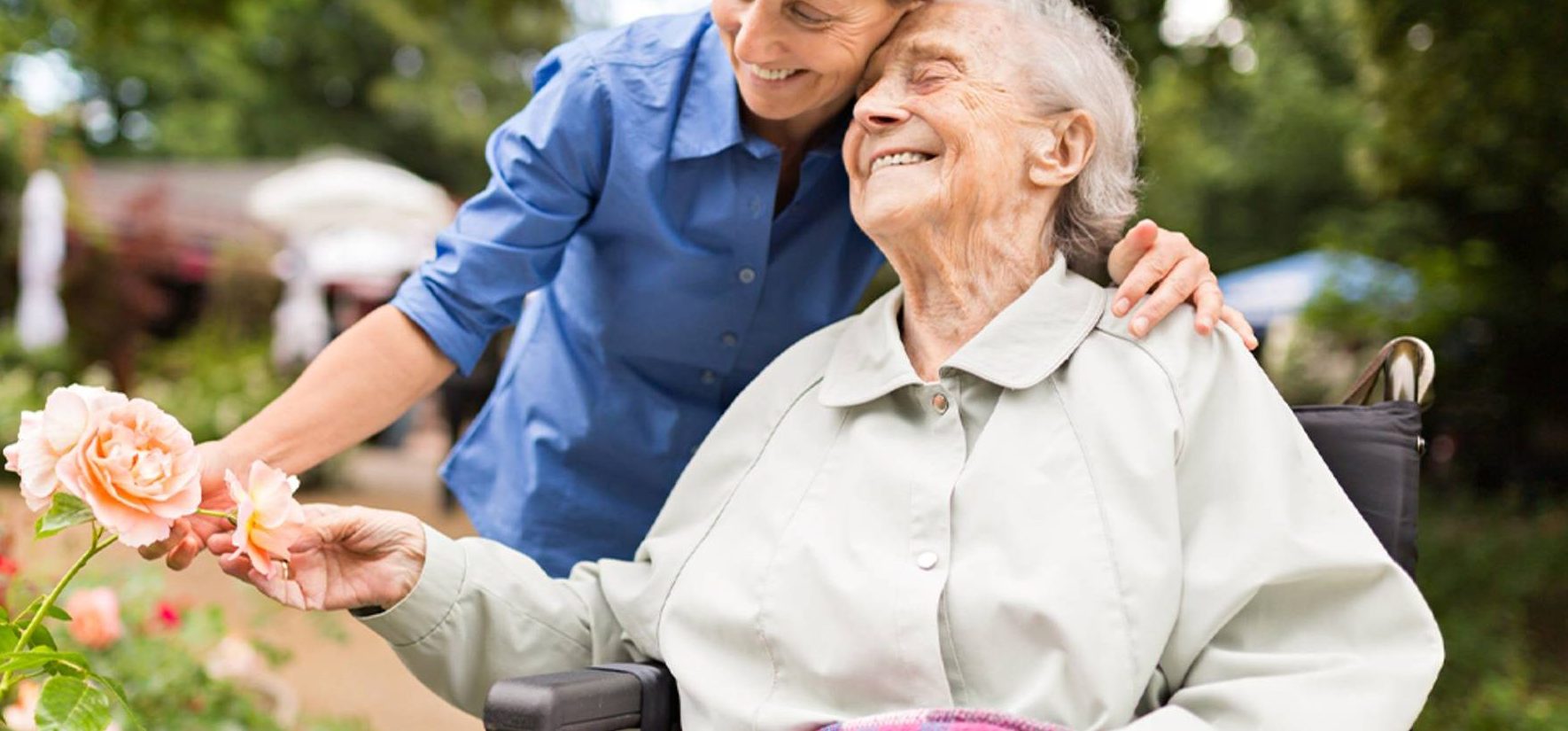 Senior woman holding flowers on a walk in her retirement community
