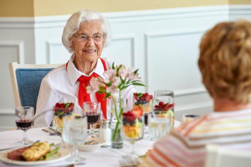 female resident smiling while dining