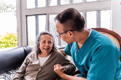 Caregiver and Senior woman talking at the hospice